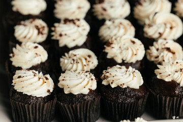 Small white whipped cream swirls arranged like mini pyramids for dessert decoration