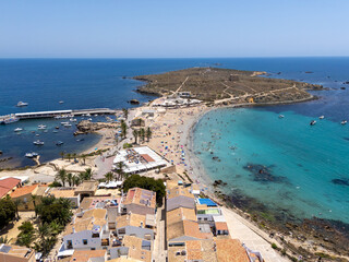 Aerial view of a scenic Mediterranean beach with turquoise waters, sandy shore, and coastal village...