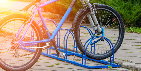 Bicycle parked securely in a bike rack during a sunny afternoon in an urban area