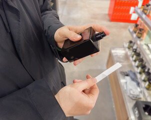 Man buying make up at cosmetics section in store. choosing cosmetics, perfumes, creams and...