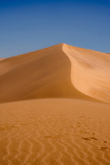 Mingsha Mountain and Crescent Lake in Dunhuang, Gansu Province - Desert scenery under clear sky