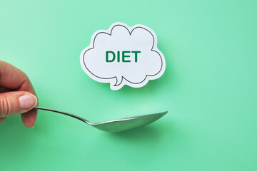 An empty spoon and the inscription: Diet, following a diet, and proper nutrition