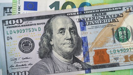Close-up of US 100 dollar and 100 euro banknotes. Concept of currency exchange, euro-dollar...