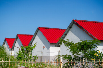 cottages with red roof and blue sky