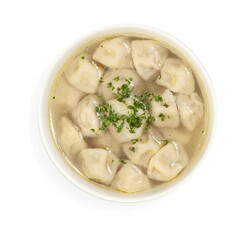 A bowl of soup with dumplings and parsley on a white background
