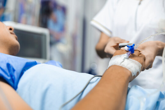Nurse inserting an intravenous line in a hospital setting