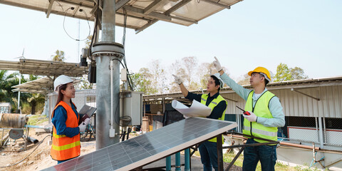 Sustainable Energy. Engineers inspecting solar panel installation.