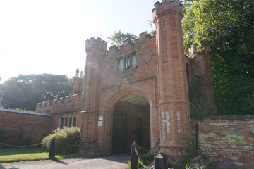 Nottinghamshire, England - June 20 2025: Historic red-brick Gothic gatehouse with diamond patterns,...