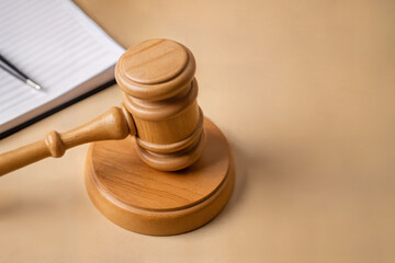 wooden judge gavel and notebook on wooden table, law concept