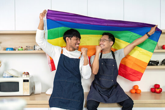 LGBTQIA Pride Celebration: Joyful Couple with Rainbow Flag