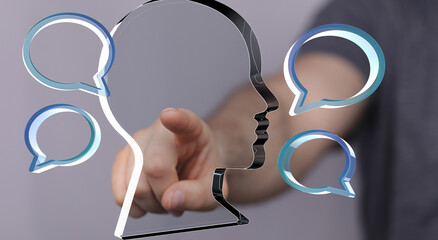 Concept image:  Person interacts with digital speech bubbles and a head profile, representing...