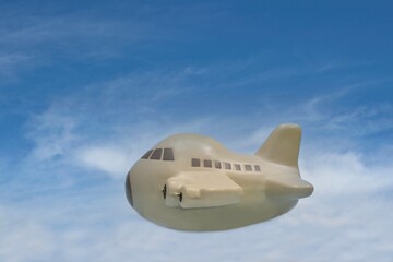 Toy plane flying through sky holiday travel cargo freight transportation concept with copy space.