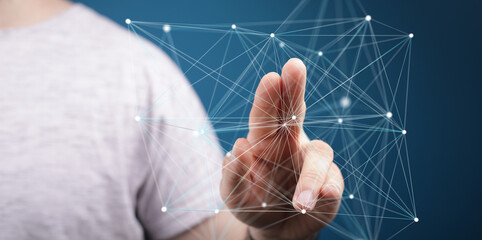 Abstract image of a hand interacting with a digital network, representing connection, technology,...