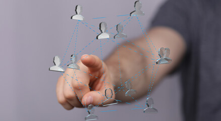 Hand interacting with a digital network of interconnected people.  Concept of social media,...