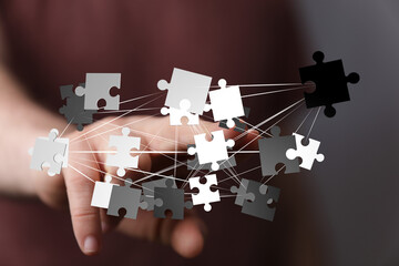 Image depicts interconnected puzzle pieces, symbolizing teamwork, problem-solving, and strategic...