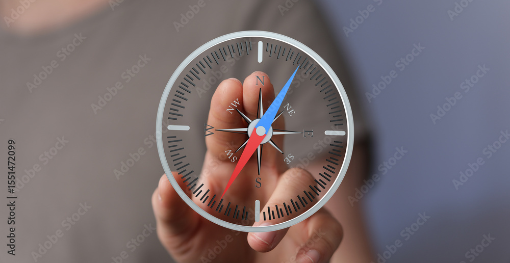Aufkleber Hand interacting with a virtual compass, showing direction and guidance.  Concept of navigation, exploration, and finding your way.