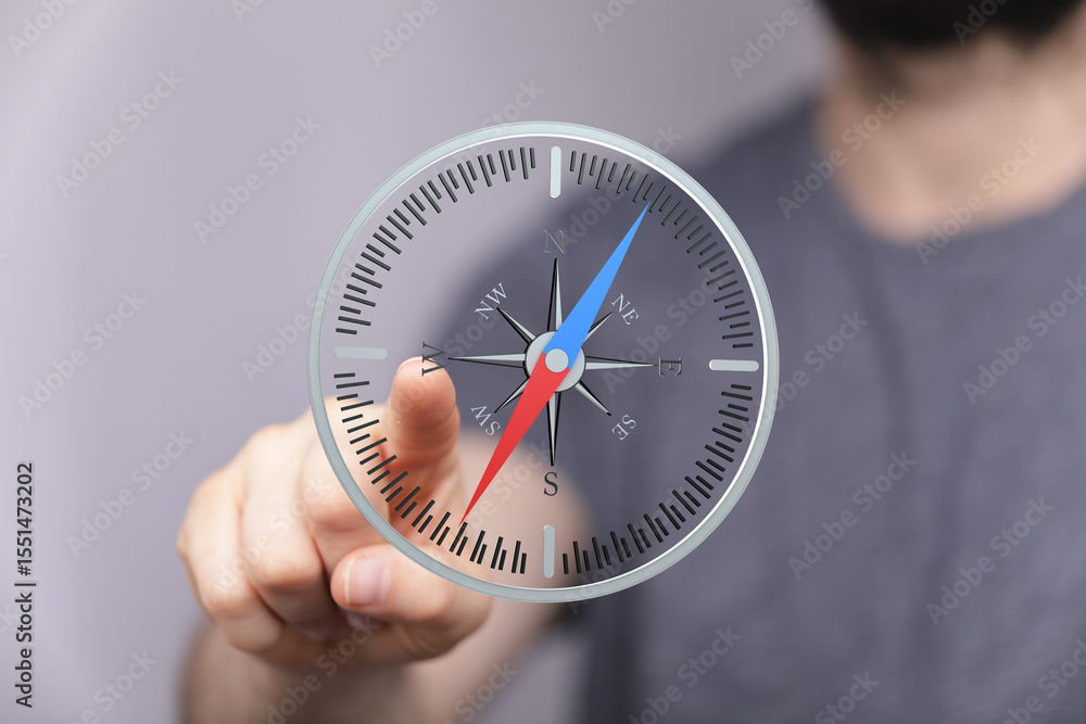 Aufkleber Find your way with this image of a person interacting with a digital compass.  Ideal for navigation, direction, and guidance concepts.