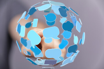 Abstract image of a hand interacting with a sphere of speech bubbles, representing global...