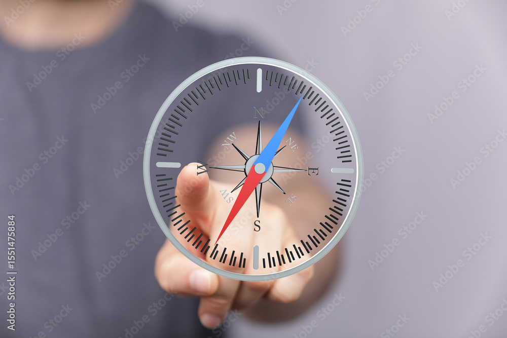 Poster hand interacting with a virtual compass, illustrating direction, guidance, and strategy.