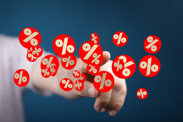 Image of a hand interacting with digital percentage symbols, ideal for finance, discounts, or sales...