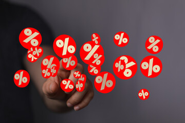 Image of a hand interacting with floating percentage symbols, ideal for discount, sale, and finance...