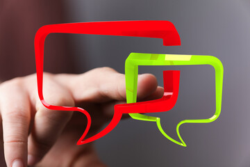 Hand interacting with 3D speech bubbles.  Perfect for communication, dialogue, and conversation...