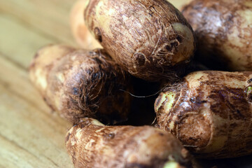 Group Of Taro Root Vegetable On Wooden Table Close Up