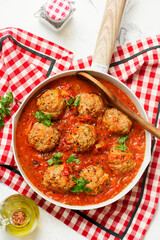 Minced meatballs in tomato sauce in a frying pan.top veiw.selective focus
