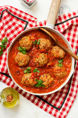 Minced meatballs in tomato sauce in a frying pan.top veiw.selective focus