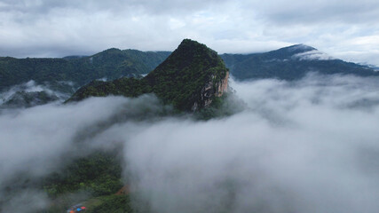 Aerial view of greenery mountains on foggy morning