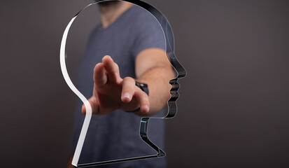 Abstract image depicting a man interacting with a transparent head, symbolizing mind control,...