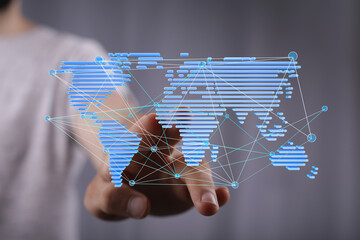 Hand interacting with a digital world map, showcasing global connectivity and networking.