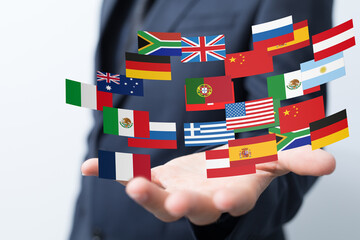 Hand holding diverse flags, symbolizing global reach and international business connections.