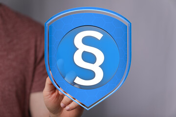 Secure legal protection concept.  Digital shield with paragraph symbol.