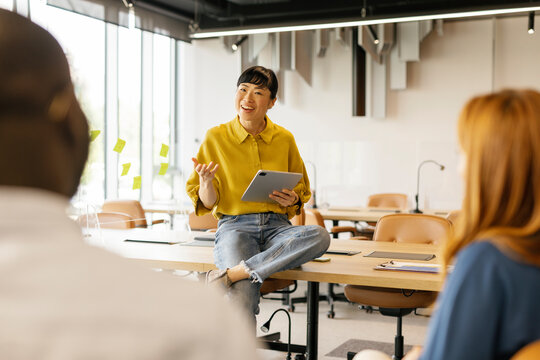 Businesswoman in casual clothes presenting on a desk in a modern office