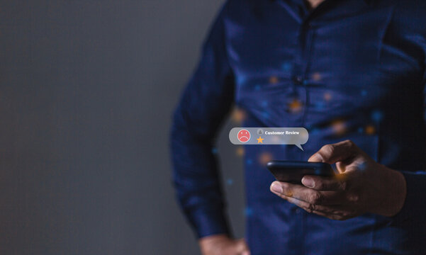 Consumer Satisfaction, Young man with smartphone hand holding to review and gives 1 star, with poor service results, Bad review Rated just 1 star Feedback options