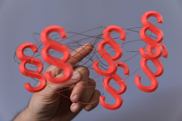 Abstract image of interconnected red paragraph symbols.  Concept for law, legal, justice.