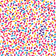 Colorful candy sprinkles seamless pattern with multicolor confectionery confetti shapes on white background for sweet dessert design and decoration