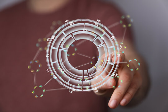 Person interacts with a futuristic digital dashboard displaying data analysis.