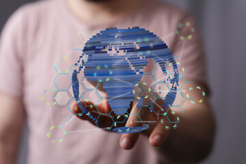 Person interacting with a digital globe, showcasing global connectivity and technology.