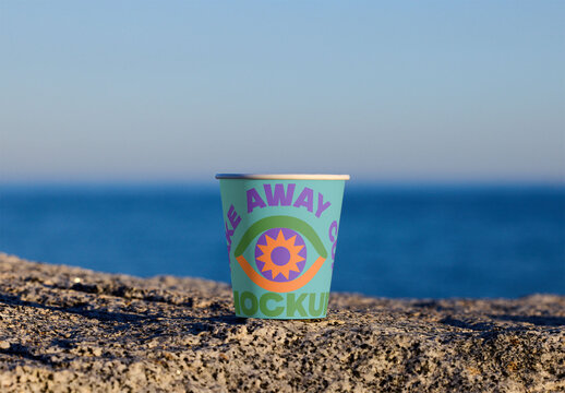 Sustainable Takeaway Cup Mockup on Rocky Shore