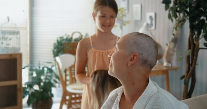 With her daughter's loving support, Mom confidently removes her wig, embracing her short-cut hair after chemotherapy. A beautiful moment of self-acceptance and family strength at home.