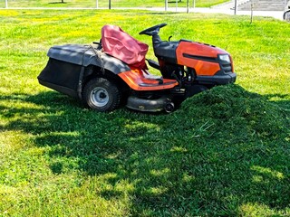 Lawn mower and cutted green fresh grass