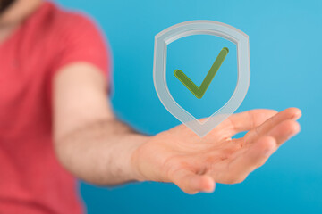 Image of a hand holding a digital shield with a checkmark, symbolizing data security and protection.