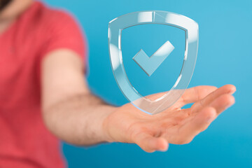 Hand holding a digital shield, representing data security and online protection.