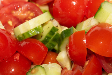 Fresh Salad Tomatoes and cucumber chopped up on white background