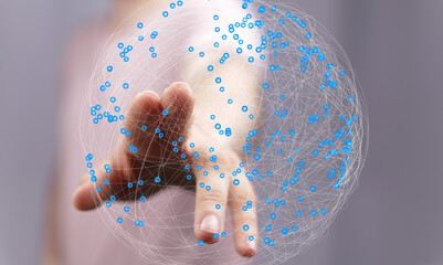 Abstract image of a hand interacting with a digital global network. Represents connection,...