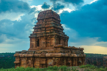 Ancient temple in Badami, Karnataka. The overcast sky adds intensity to the rugged terrain and the...
