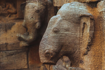 Ancient temple wall carvings of elephant head in Badami, Karnataka, India, reflecting Indian...