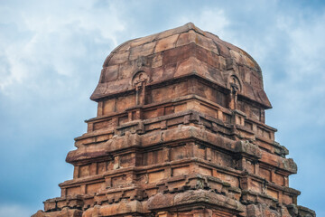 Ancient temple in Badami, Karnataka. The overcast sky adds intensity to the rugged terrain and the...